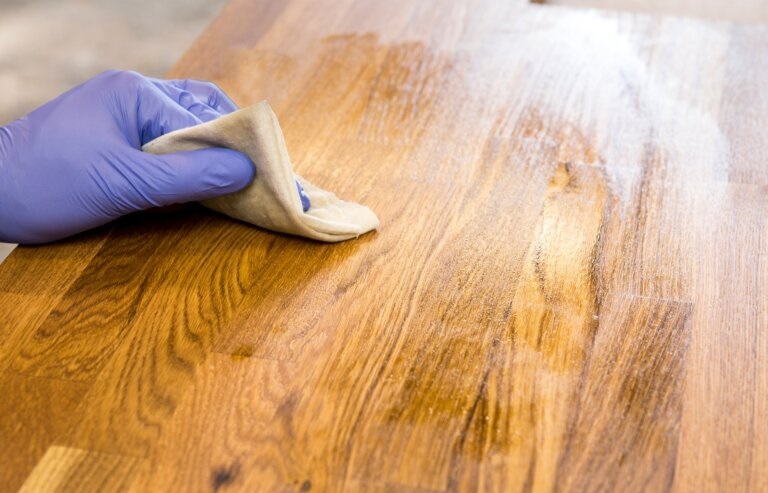 applying oil finish on wooden table