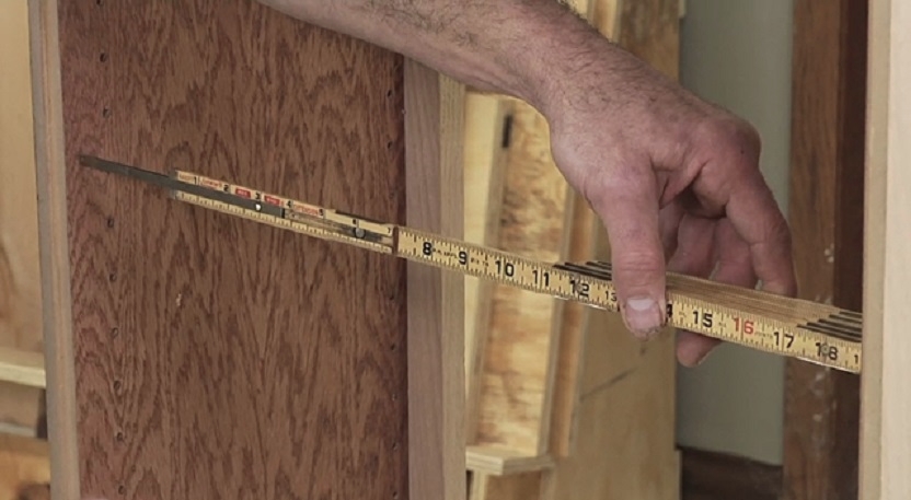 using a folding ruler to measure furniture